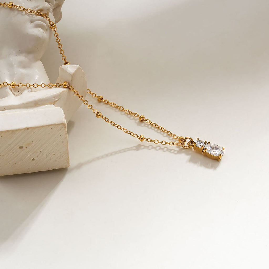 CABBANA Gold: A Duo Set of Zirconia Charm Pendants on a Beaded Chain Necklace - MacroPanora