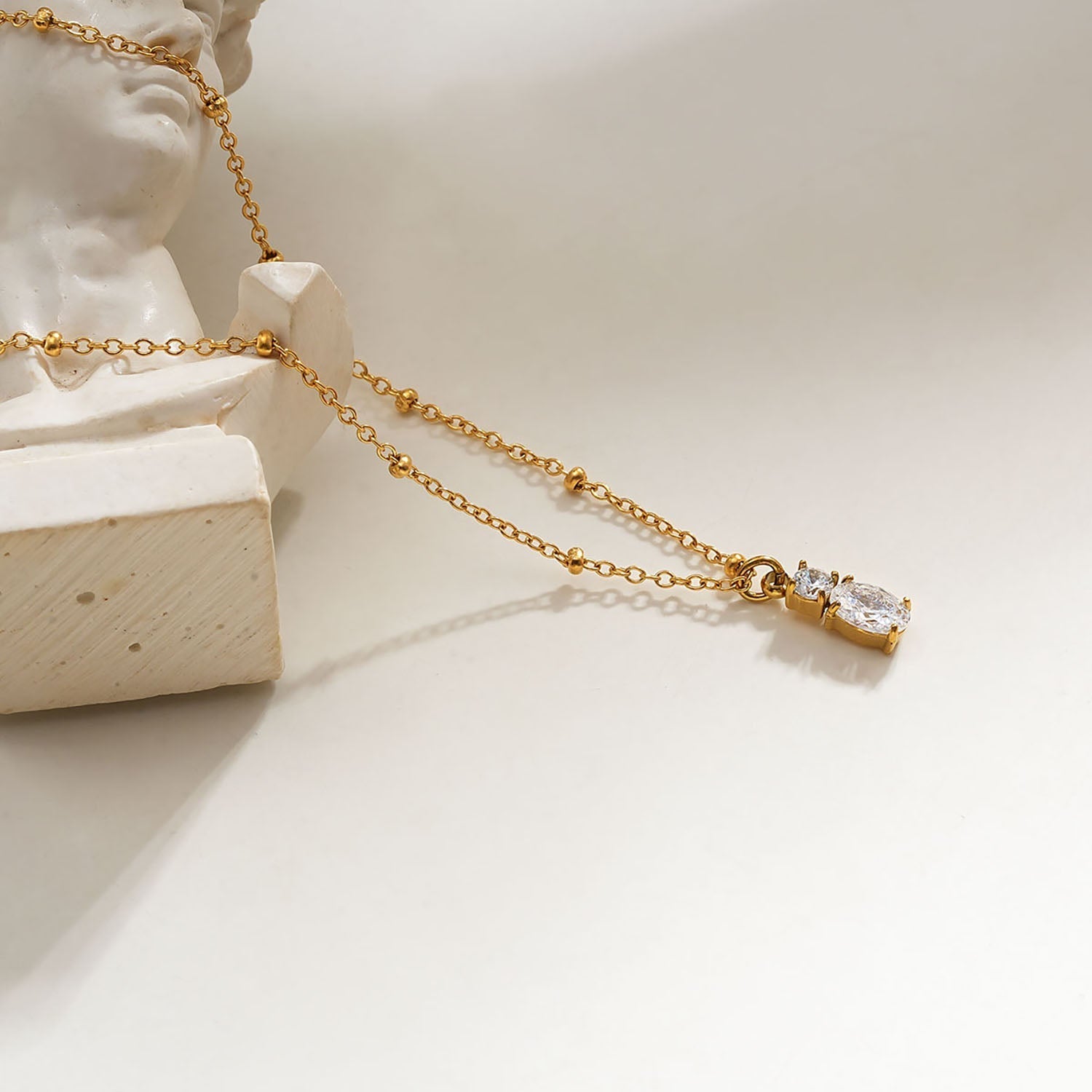 CABBANA Gold: A Duo Set of Zirconia Charm Pendants on a Beaded Chain Necklace - MacroPanora