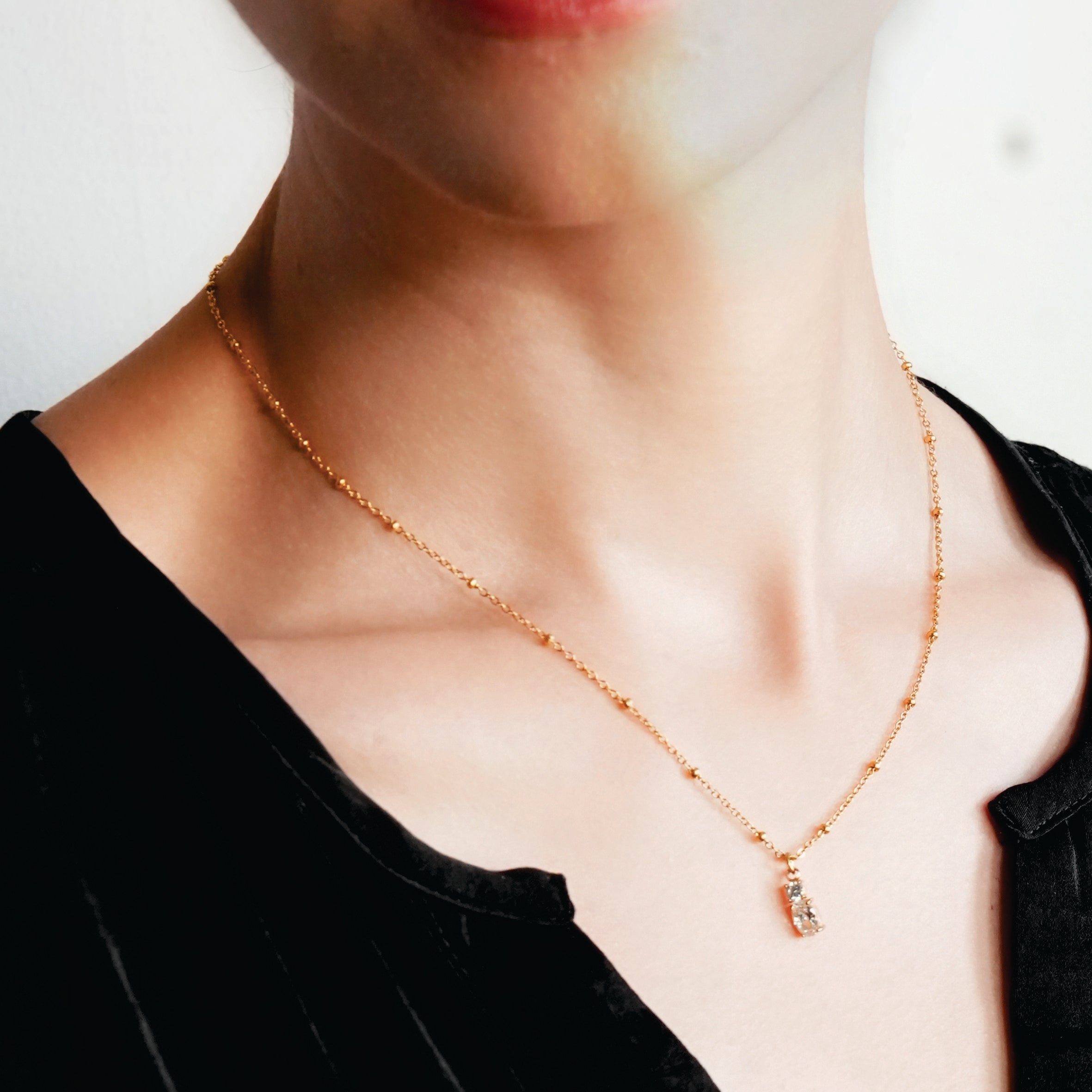 CABBANA Gold: A Duo Set of Zirconia Charm Pendants on a Beaded Chain Necklace - MacroPanora
