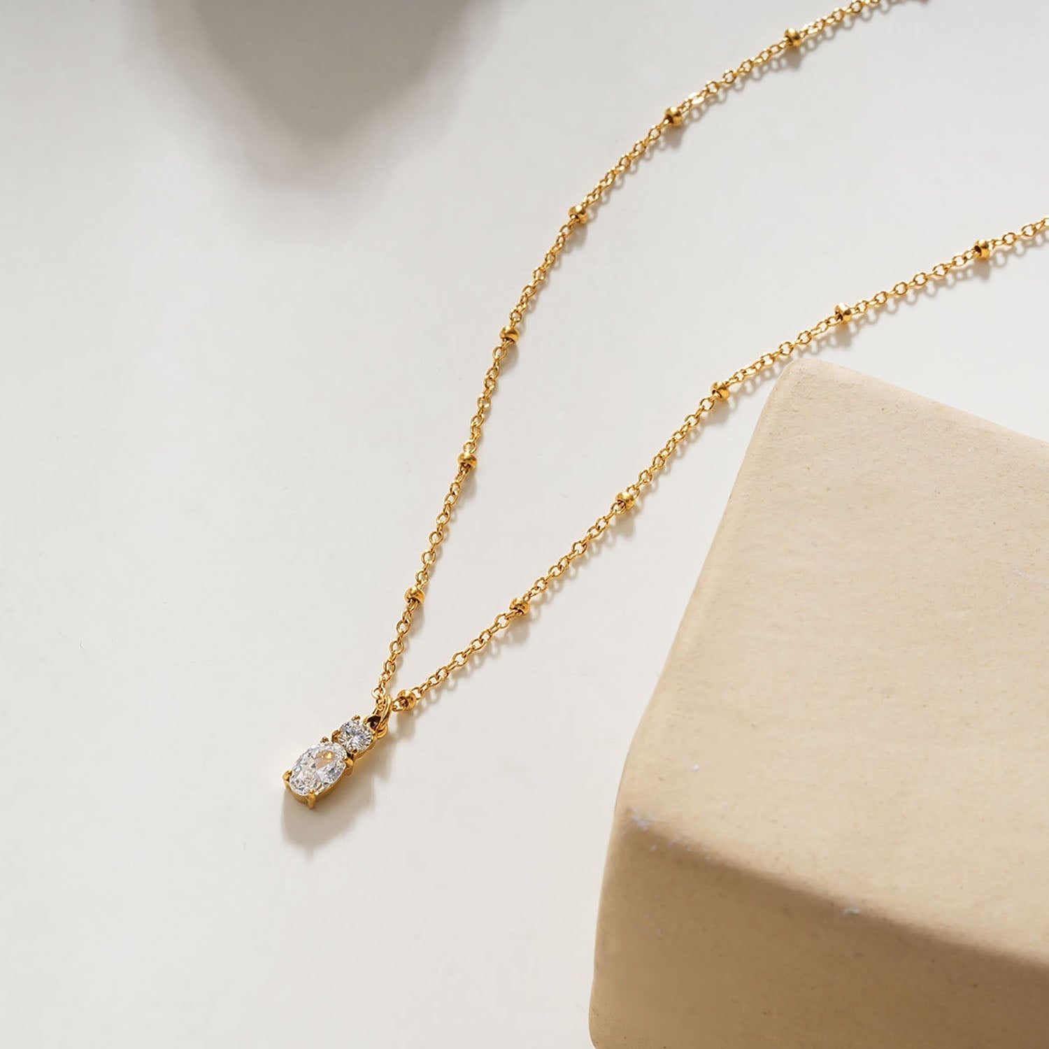CABBANA Gold: A Duo Set of Zirconia Charm Pendants on a Beaded Chain Necklace - MacroPanora