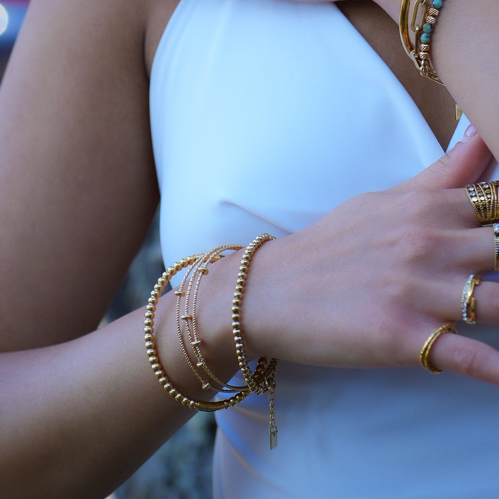 Style FARZIKA Gold: Triple Stacked Textured Beaded Bracelet - MacroPanora