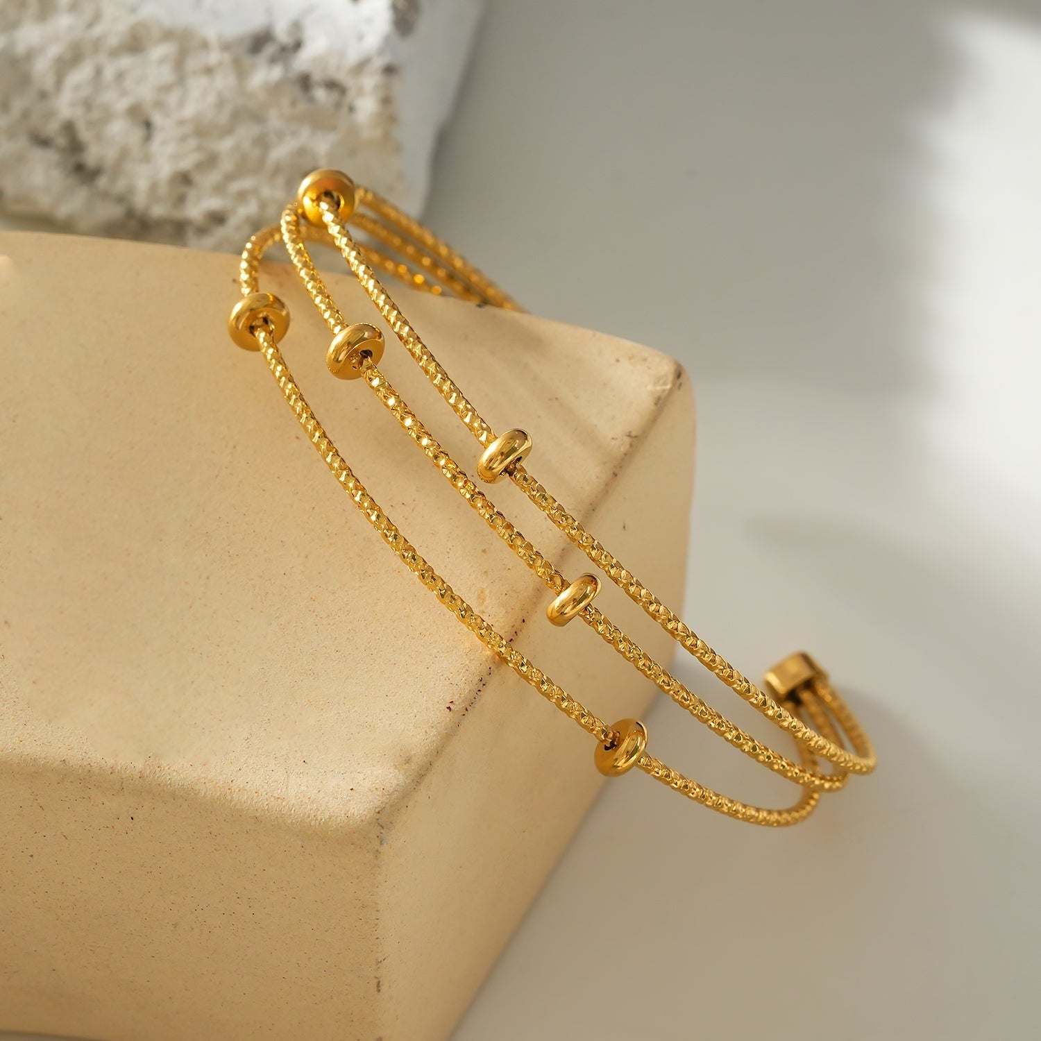 Style FARZIKA Gold: Triple Stacked Textured Beaded Bracelet - MacroPanora