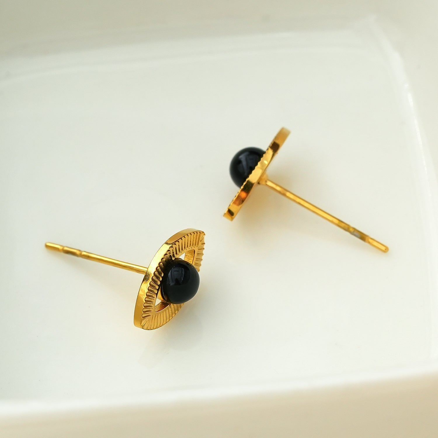 TAVIRA: Gold Evil Eye Studs with Black Onyx Embellishment - MacroPanora