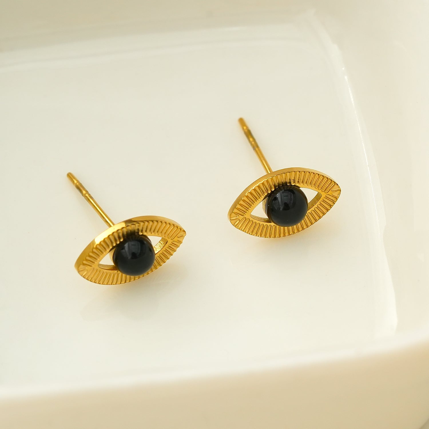 TAVIRA: Gold Evil Eye Studs with Black Onyx Embellishment - MacroPanora